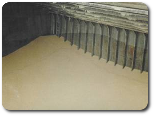 Photo of the interior of a barge with corn in it.